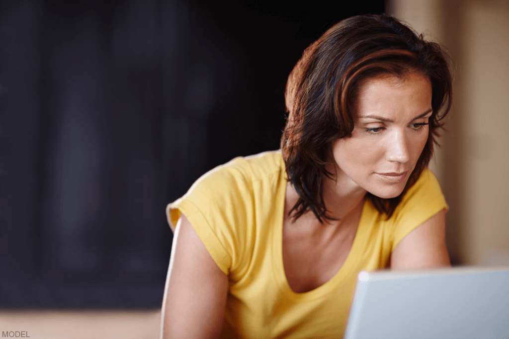 Woman performing research on a laptop