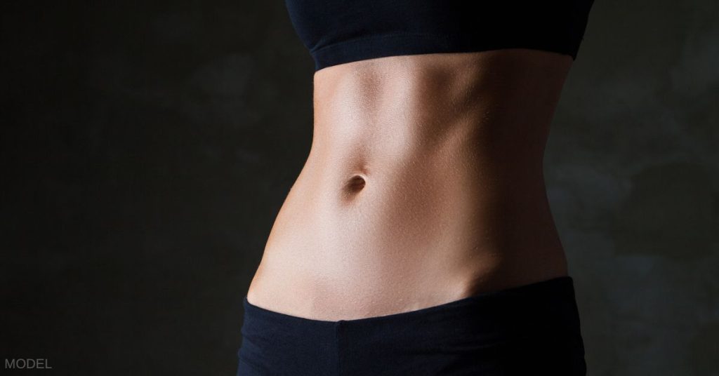 Woman's flat torso (MODEL) against black background.